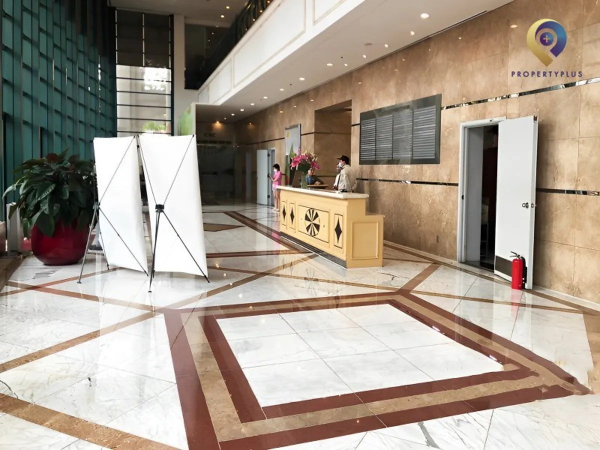 Reception area at Daeha Business Center with modern design and marble floor.